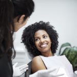 woman in dental chair discussing cosmetic dentistry
